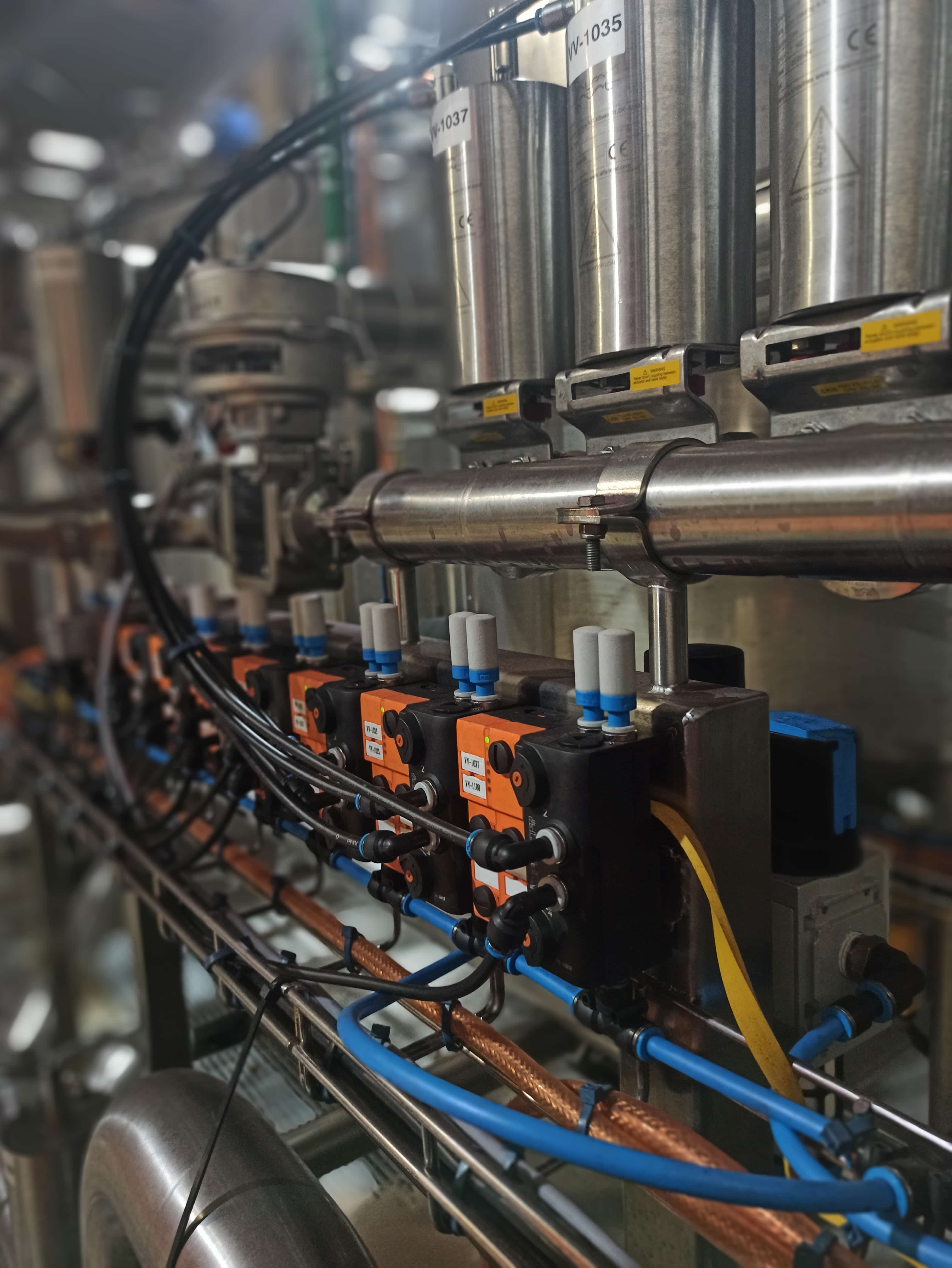 Industrial automation engineers working beside a production line in a manufacturing facility