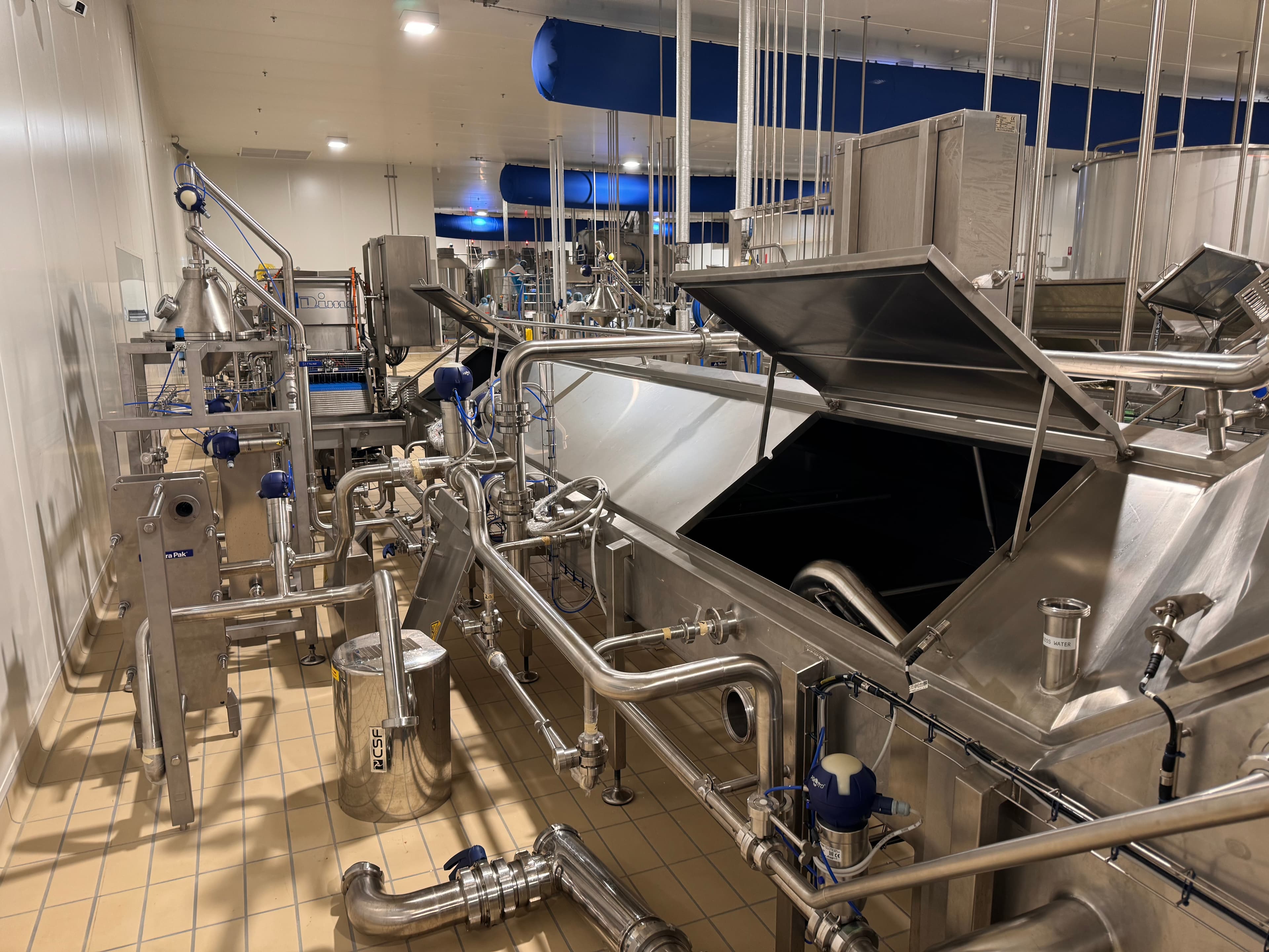 Food processing line with stainless steel equipment in a production hall